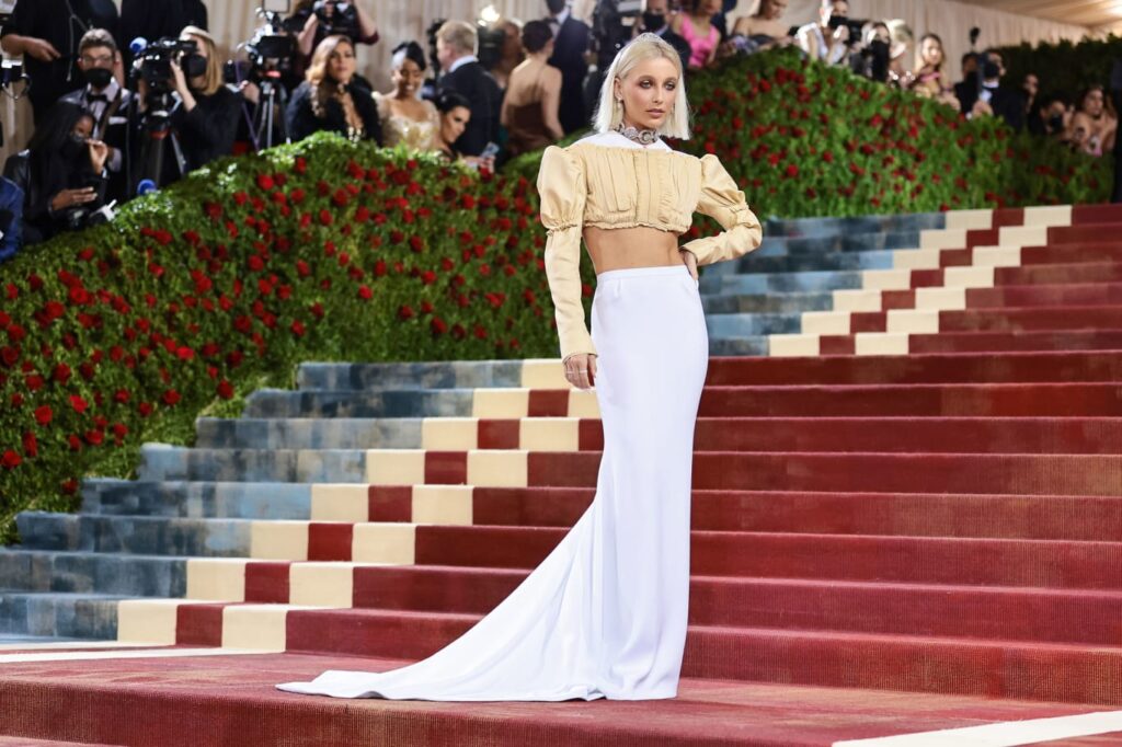 Emma Chamberlain in a cropped, two-piece look with a modernized nod to 19th-century tailoring. Credit: Jamie McCarthy/Getty Images