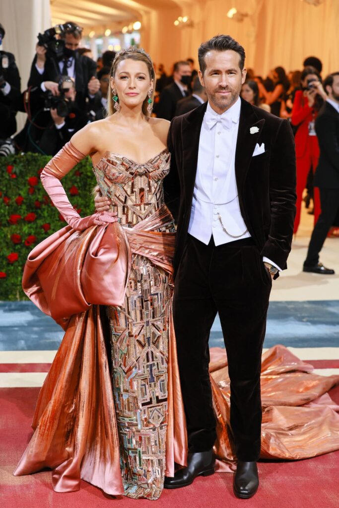 Actors Blake Lively and Ryan Reynolds embraced the theme, with Lively in a glittering Versace beaded gown with an oversized coppery satin bow and matching gloves, and Reynolds in a classic tuxedo. Credit: Theo Wargo/WireImage/Getty Images