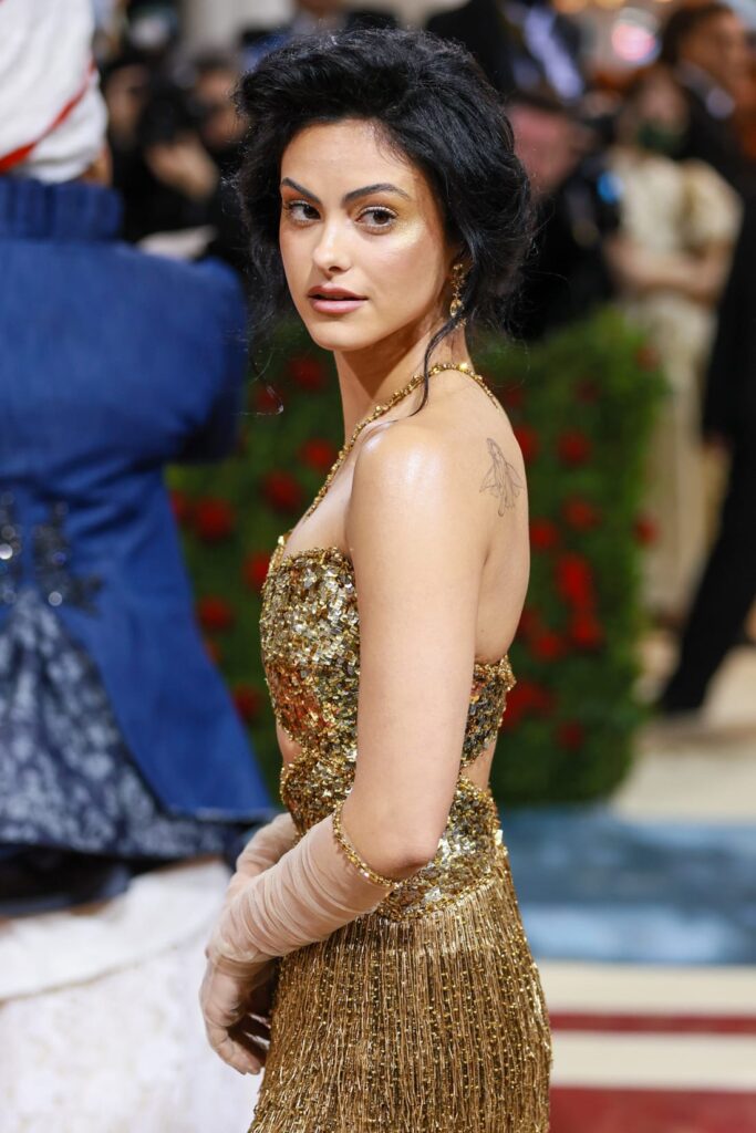 Camila Mendes opted for a fringed gold dress with sequined top and cut-out. Credit: Theo Wargo/WireImage/Getty Images