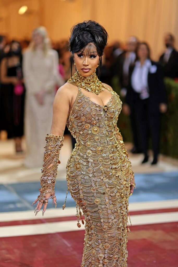 Rapper Cardi B turned to Versace for this chain-embellished dress, which was made from a mile of golden chains according to the brand. Credit: Dimitrios Kambouris/Getty Images for The Met Museum/Vogue