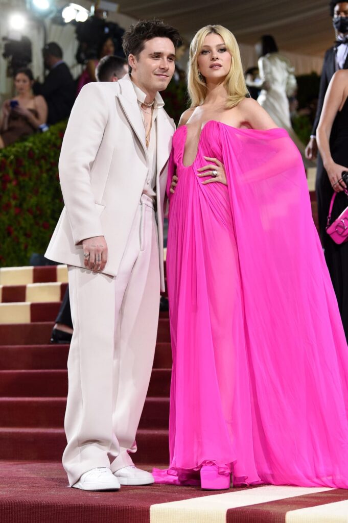 Brooklyn Beckham and Nicola Peltz both opted for Maison Valentino creations, with Peltz wearing a neon pink gown with a plunging neckline in contrast to Beckham's ivory suit. Credit: Evan Agostini/Invision/AP